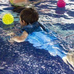 image showing aquababes ni baby swiming lessons with baby swimming wearing orby suit
